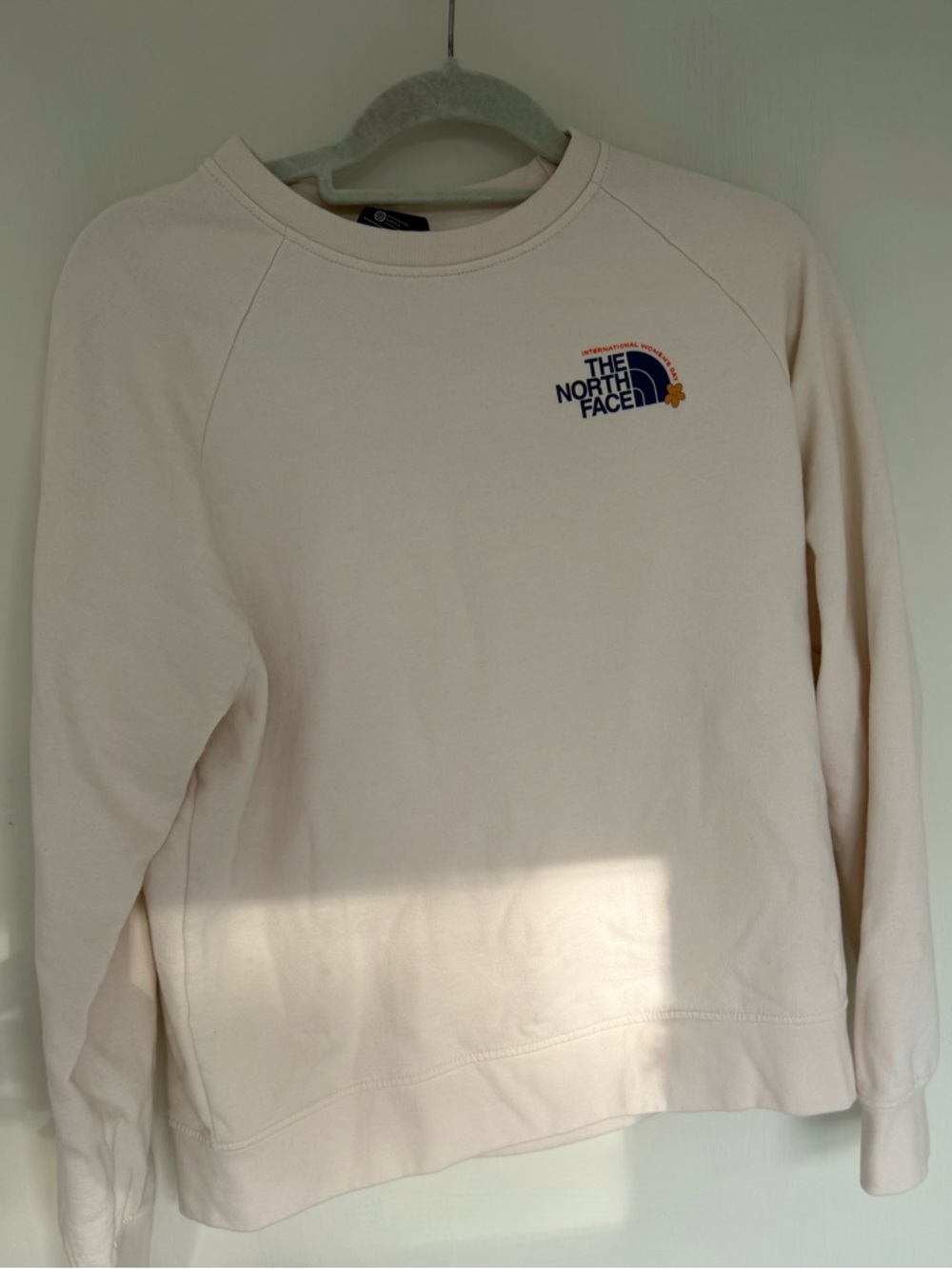 The North Face Women's Cream Pullover with Blue Logo and Orange Accent